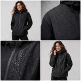 Detailaufnahmen der schwarzen Regenjacke – abperlende Regentropfen und aufscheinender Leoparden-Print