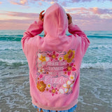 Florina Coast Hoodie Rückseite mit großer Blumenstickerei am Strand
